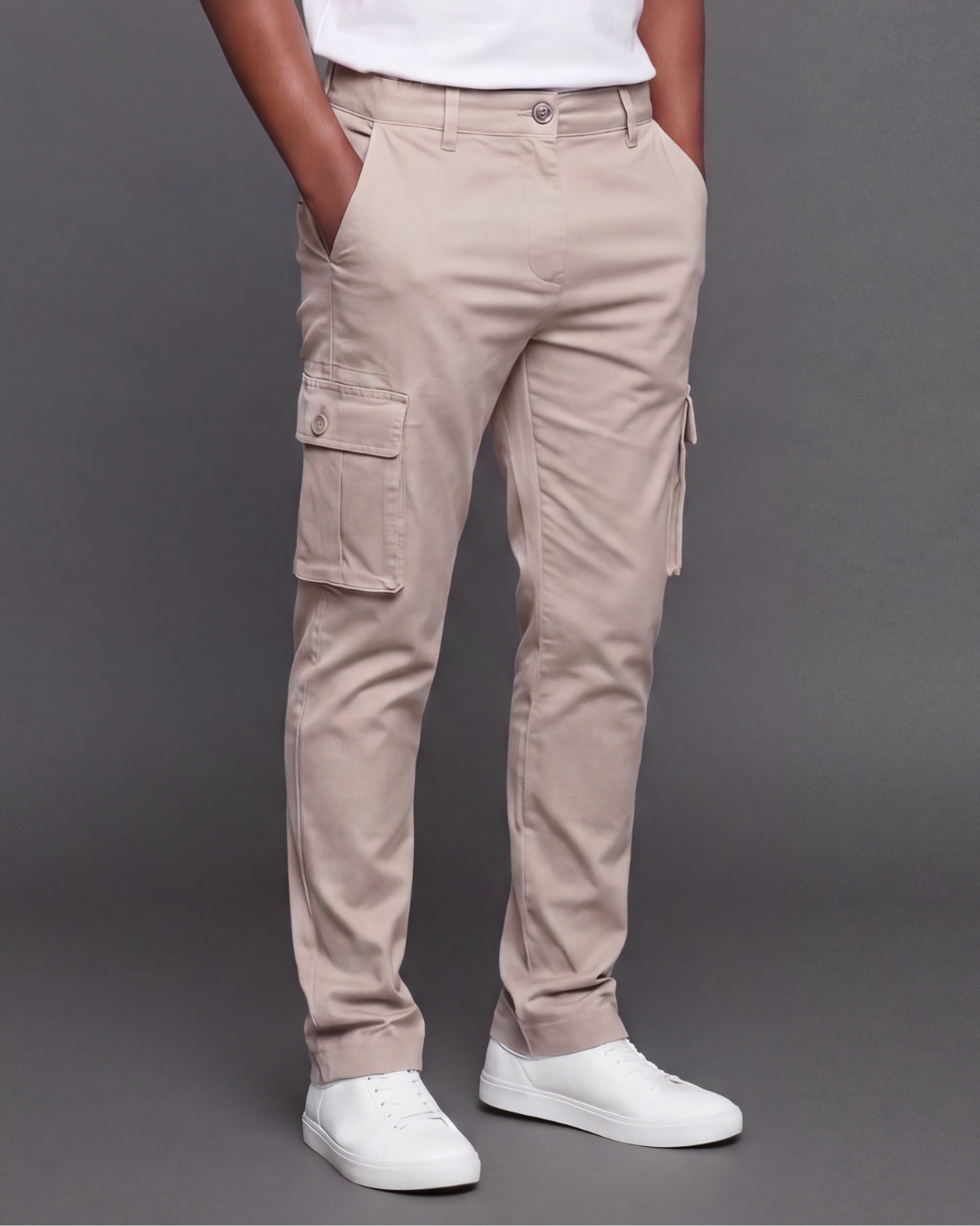 Beige cargo pants worn by a boy on a gray background