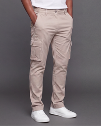 Beige cargo pants worn by a boy on a gray background