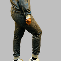 The image focuses on the unique ribbed design, adding a sleek and sophisticated element to the sweatpants.