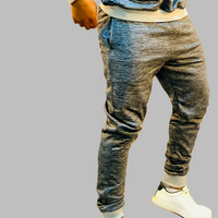  The image showcases the timeless grey color and the relaxed yet tailored fit of the sweatpants