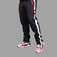 Men's black 320 GSM fleece sweatpants with white side stripe and red accents, worn as a set with the matching stripe sweatshirt — Exetwear, made to order in Nairobi