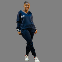 A model wearing the navy blue Women Tech Fleece Sweatsuit, showcasing its flattering fit and stylish design