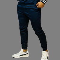 Side view of navy blue men's sweatpants showcasing ribbed cuffs and tech fleece fabric.